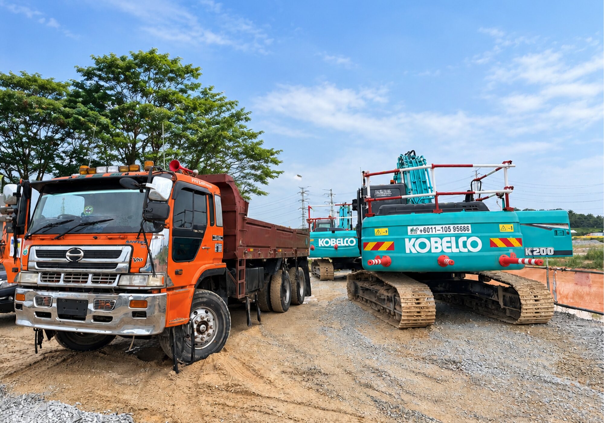 Tipper truck parked beside a Kobelco tracked excavator on an infrastructure works site
